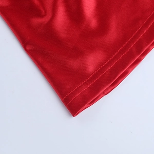 Macro shot of double-line stitching on red satin fabric of an off-shoulder dress