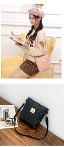 Close-up of quilted pattern and gold twist lock on pink and black crossbody bucket bags