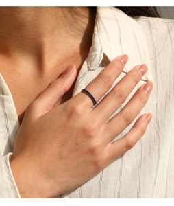 Close-up of S925 sterling silver ring with delicate blue zircon inlay on finger