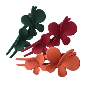 Three matte butterfly hair clips in dark green, dark red and orange colors