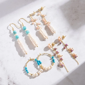 Retro S925 silver earrings with baroque pearls and pink gemstones in natural sunlight