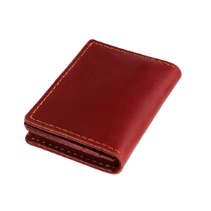 Close-up of red crazy horse leather card holder with thick yellow contrast stitching
