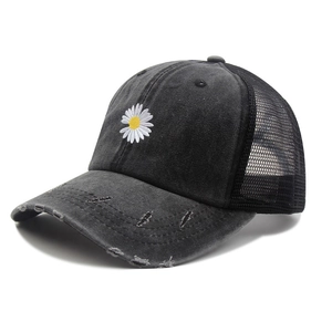 Detail of distressed black baseball cap with white daisy embroidery and mesh back
