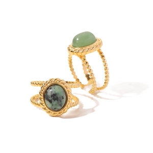 Gold stainless steel rings set with African turquoise and green stones on white background