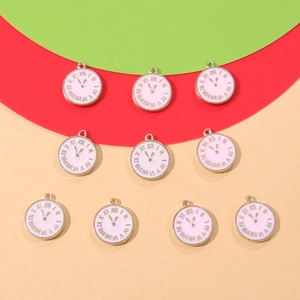 Flat lay of pink enamel clock pendants with gold-plated borders for DIY jewelry making