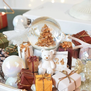 Vintage musical Santa snow globe with golden tree, polar bear and holiday gift boxes