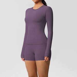 Detail view of the high-waist shorts and slim-fit long sleeve top in purple yoga set