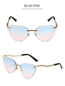 Detail of rimless cat-eye sunglasses with blue-pink gradient lenses and gold spiral temples