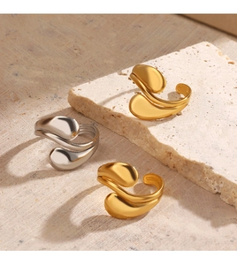 Detailed view of three teardrop adjustable rings in 18K gold and silver finishes