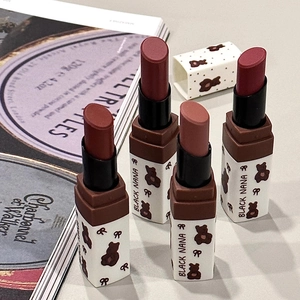 Detailed view of matte bear lip mud set in brown and red tones on a white surface