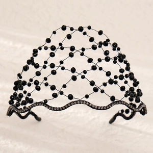 Detailed view of hand-woven black beaded mesh headband with sparkling rhinestone base