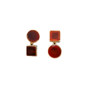 Asymmetric geometric amber resin earrings with gold trim on white background