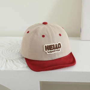 Detail of baby baseball cap with HELLO happiness embroidery and contrast khaki red colors