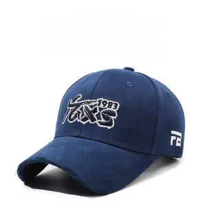 Detailed close-up of vintage navy baseball cap with white 1983 embroidery and distressed brim