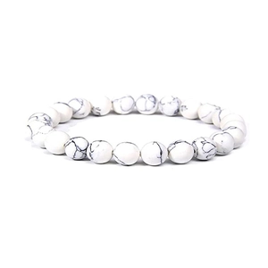Detailed view of 8mm white turquoise beads with natural black veins on elastic bracelet