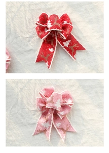 Detail of red and pink Christmas bows with reindeer patterns and frayed edges for gift wrapping