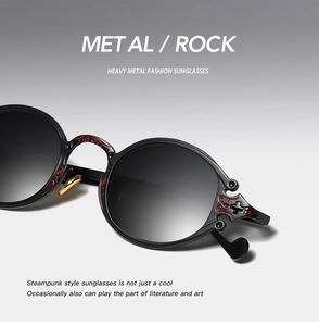 Detail shot of black steampunk sunglasses with intricate red embossed frame patterns