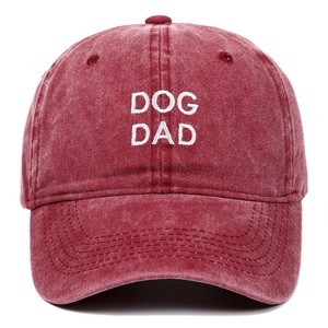 Close-up of white DOG DAD embroidery on dark red washed vintage cotton baseball cap