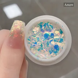 Macro shot of azure opal nail powder flakes showing sparkling aurora effect on nails