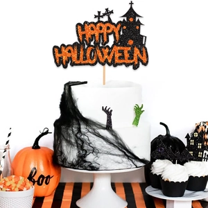 Glittering Happy Halloween cake topper with black haunted castle on a festive cake