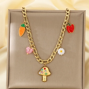 Gold stainless steel necklace with mushroom and carrot charms on gray display pad