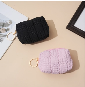 Flat lay of black and pink waffle texture coin purses with golden ring clips