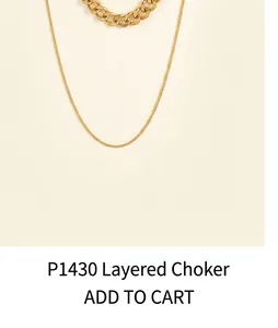 Detailed close-up of double-layer gold necklace featuring cross chain and curb chain style