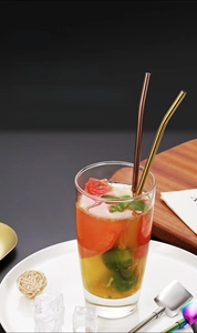 Detail of colorful 304 stainless steel straw spoons in a refreshing fruit tea glass