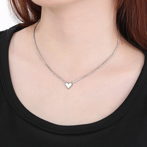 Elegant heart pendant necklace with shimmering tennis chain in polished silver steel