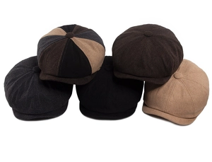 Detailed pile of thick wool newsboy caps in five vintage solid colors for autumn