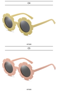 Detail view of sunflower-shaped kids sunglasses in bright yellow and soft pink colors