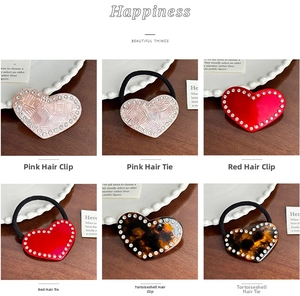 Close-up of heart-shaped acetate hair clips and ties with sparkling rhinestones in three colors