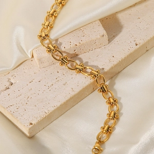 Elegant 18k gold plated stainless steel O-link chain bracelet on a textured stone base