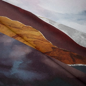 Close-up of artistic mountain tapestry fabric showing burgundy and gold marble textures