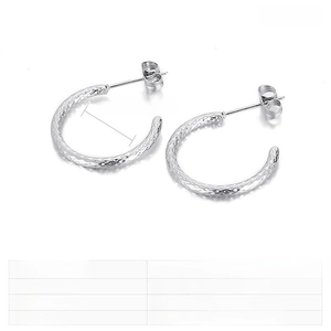 Close-up of hammered texture on stainless steel C-shaped earrings with 20mm diameter