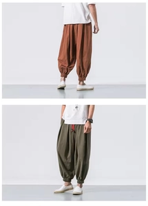 Detail view of baggy harem pants featuring elastic cuffs and cotton linen texture
