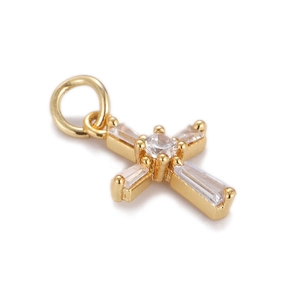 Macro shot of gold cross pendant with cubic zirconia stones and rectangular crystals