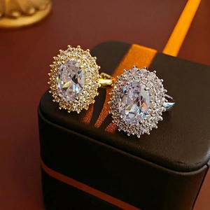Gold and silver oval halo rings with cubic zirconia stones and adjustable bands