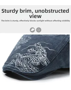 Detail of the firm denim brim and embroidered dragon pattern on this blue flat cap
