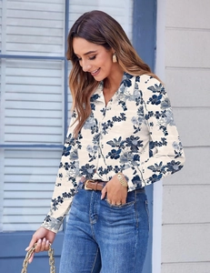 Detail of floral long-sleeved shirt featuring navy blue print and button-down collar