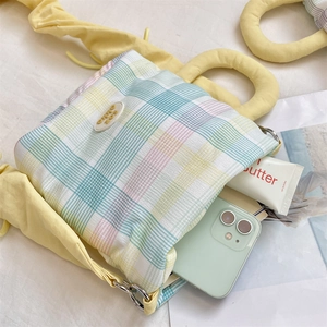 Detailed top view of a colorful plaid water bottle bag with yellow cloud handles