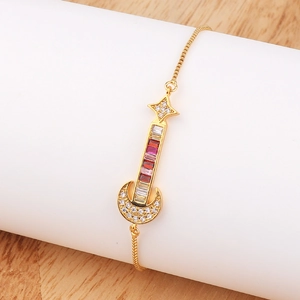 Detail of adjustable gold bracelet featuring a guitar pendant with colorful zircons