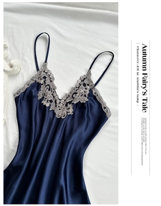 Detailed macro shot of navy blue satin nightgown with elegant floral lace embroidery decor
