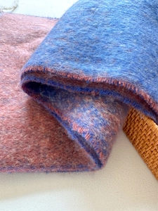 Close-up of the plush texture and blue-pink gradient weave of this thick winter scarf
