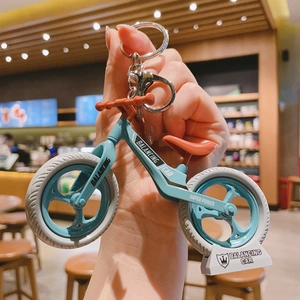 Handheld mini balancing bike keychain with morandi blue frame and display stand