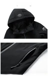 Detail of hooded jacket showing drawstring hood with logo and functional zipper pockets
