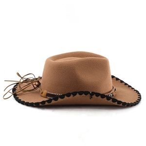 Detail of wool western cowboy hat with ethnic braided band and scallop edge trim