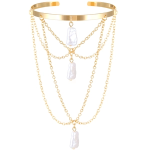 Gold multi-layer chain arm cuff with baroque pearls and tassel fringe on white background