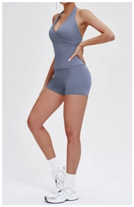 Side view of hazy blue cross V-neck halter yoga top and high waist sports shorts