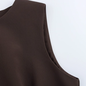 Close-up of sleeveless brown dress showing the refined shoulder stitching and knit fabric